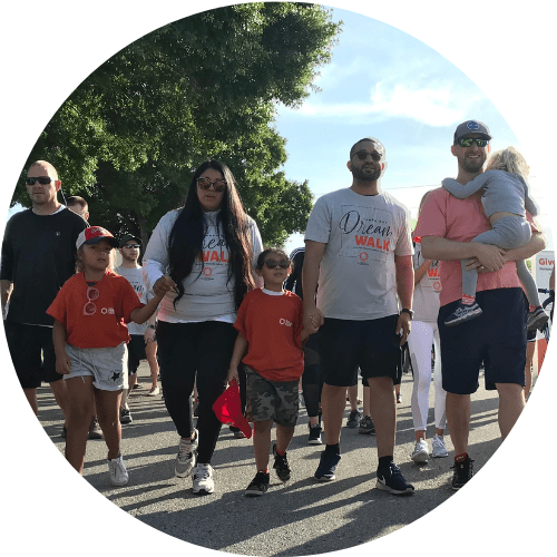 Walking Funds the Cure Circle Feature Image A group of people are participating in a community walk event, possibly "walking for a cure."